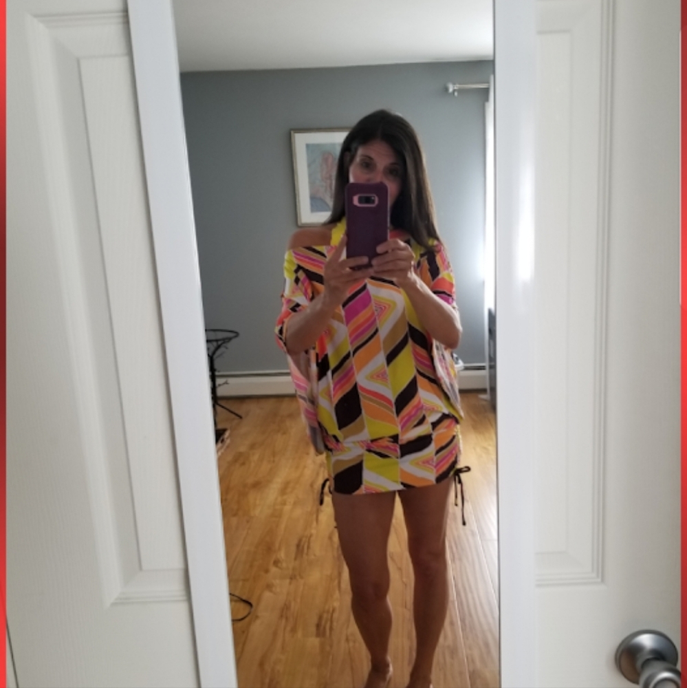 Size small Scrunch side with pull strings on sides swim cover up.